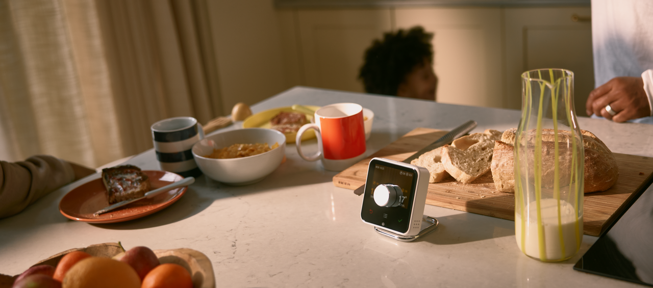 Table with breakfast items on it and a Hive thermostat